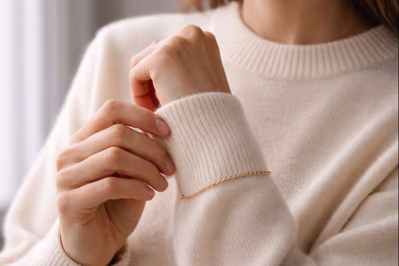 Quality cashmere and fine jewelry exemplifying quiet luxury's emphasis on exceptional materials and understated craftsmanship over visible branding.